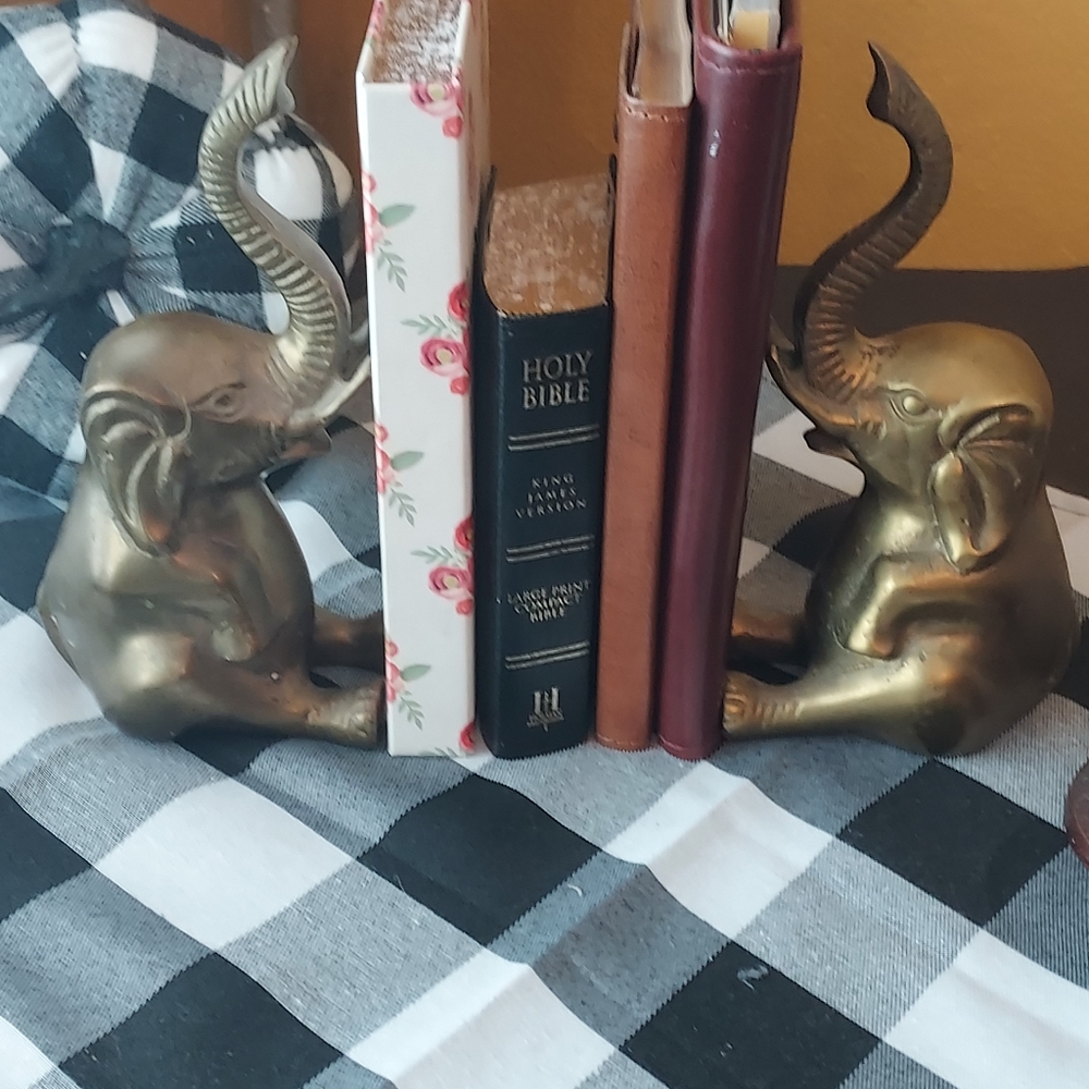 A pair of vintage Brass elephant book ends .